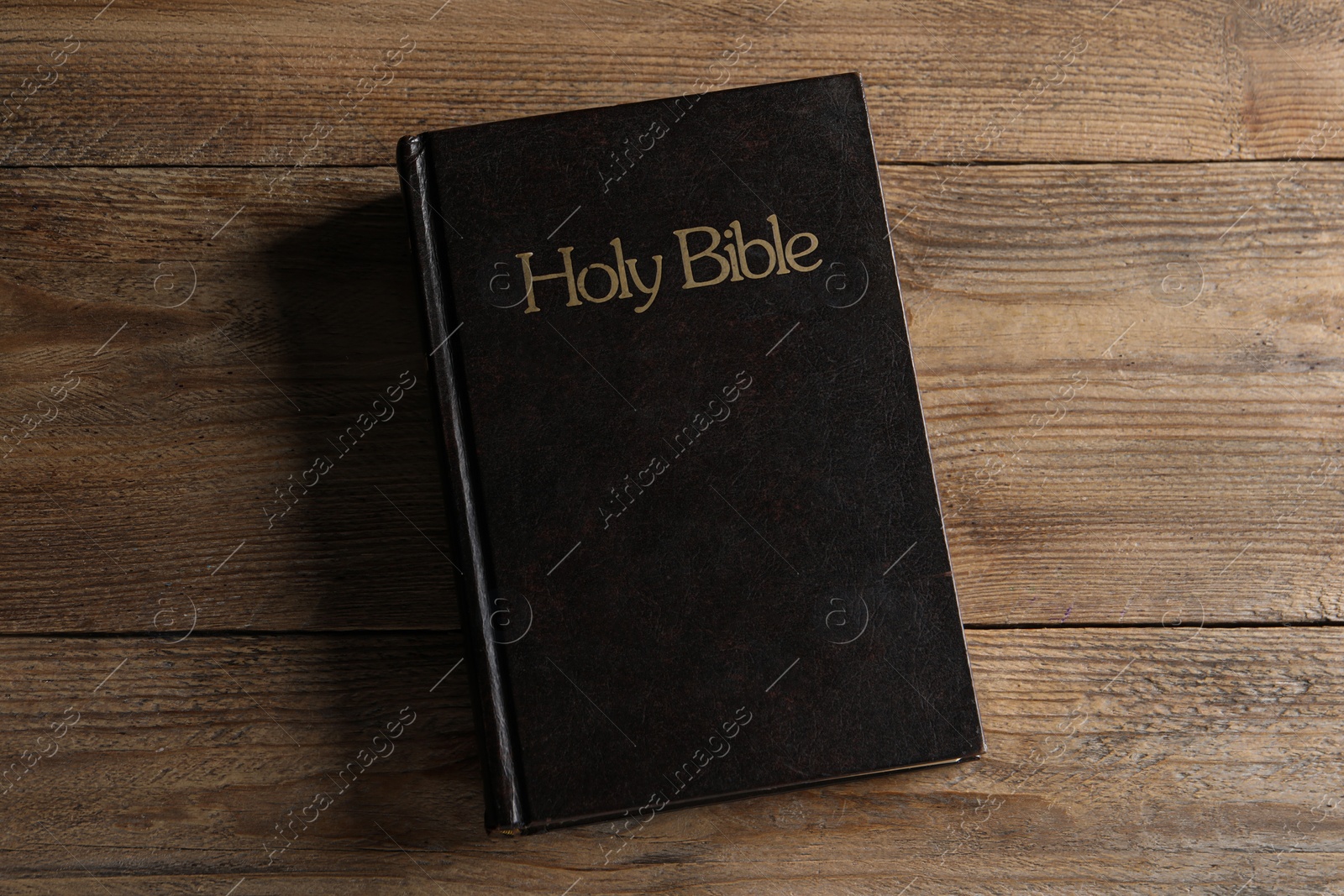 Photo of Bible on wooden table, top view. Christian religious book