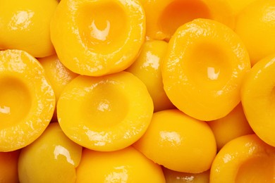 Photo of Halves of canned peaches as background, top view