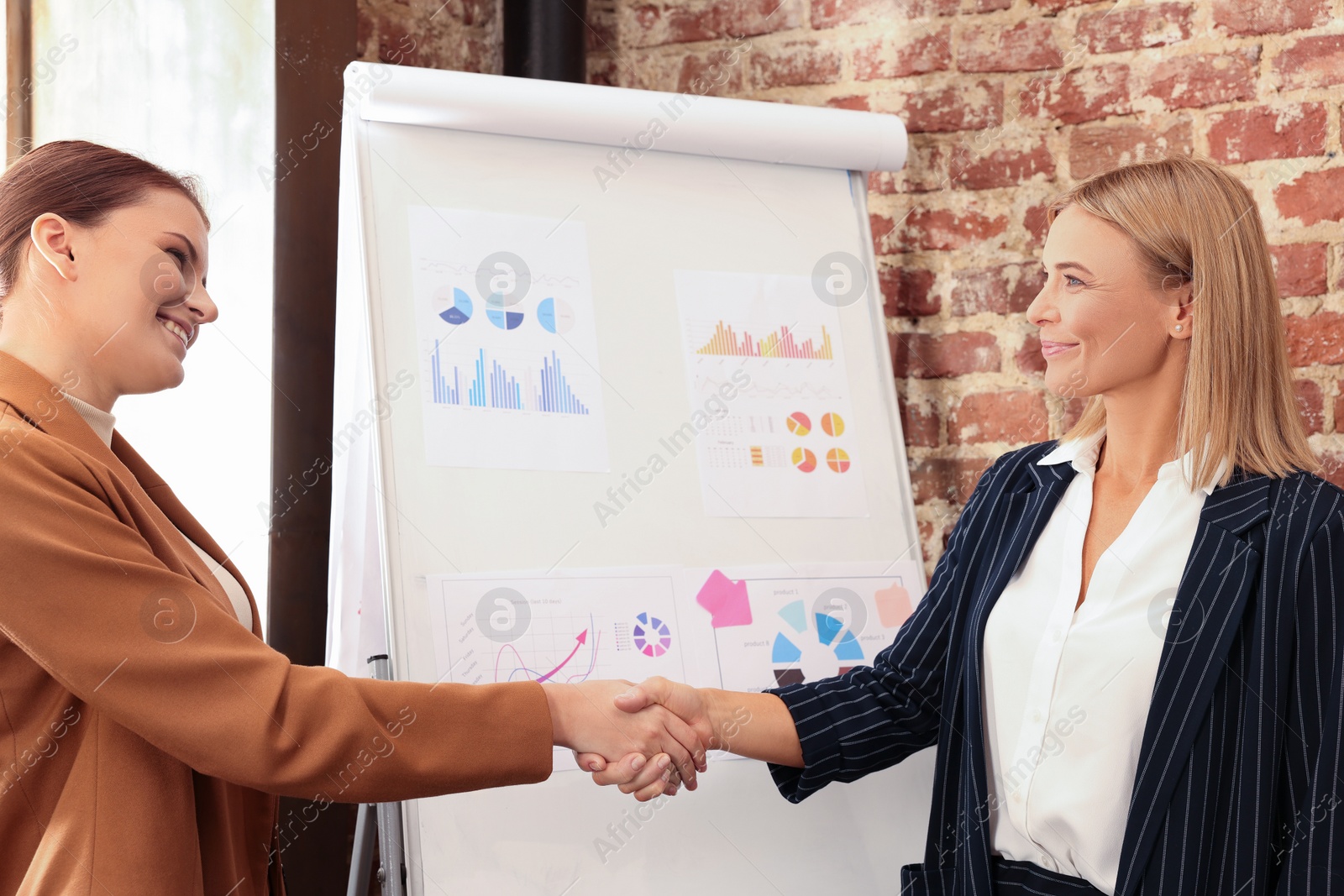 Photo of Businesswoman having meeting with her employee in office. Lady boss