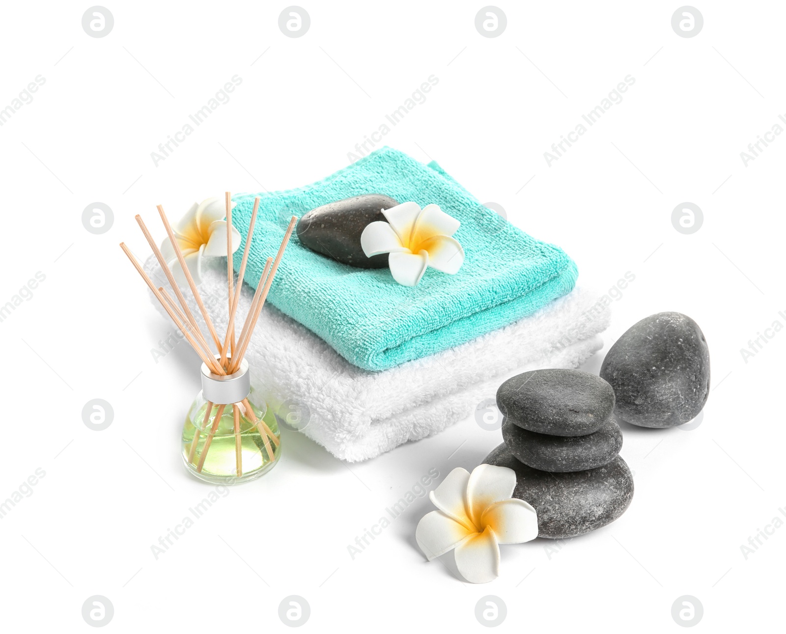 Photo of Beautiful composition with towels and spa stones on white background