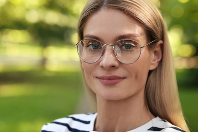 Photo of Portrait of confident female entrepreneur outdoors. Beautiful woman with glasses in park. Space for text