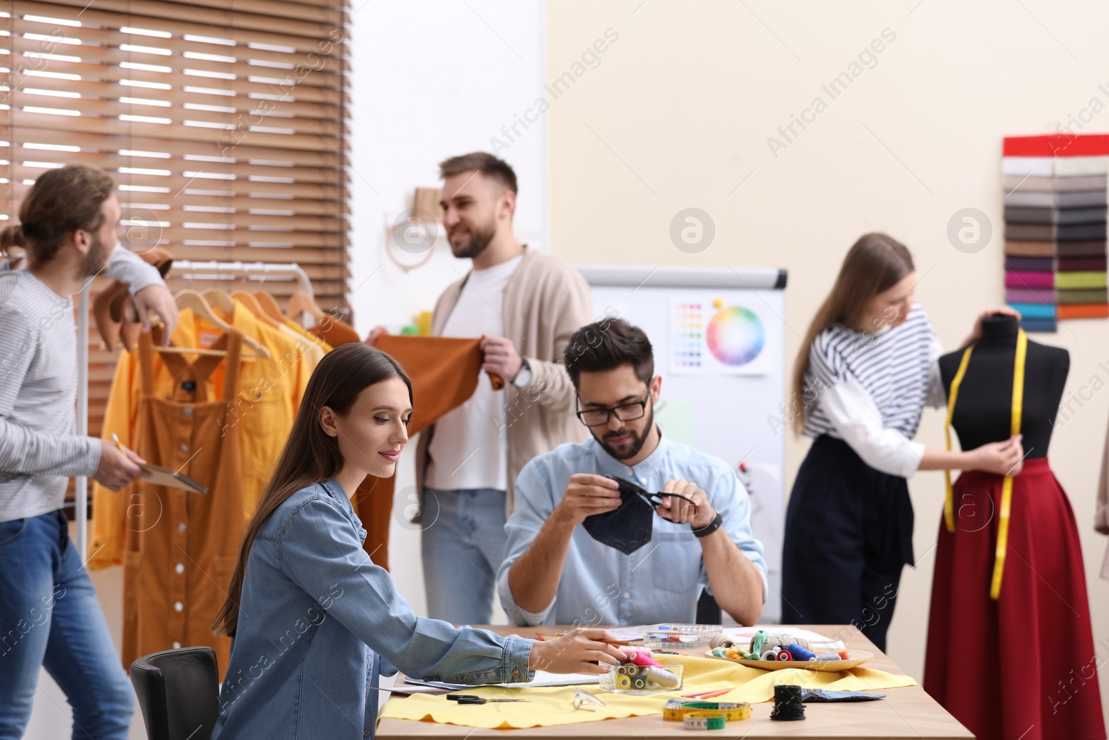 Photo of Fashion designers creating new clothes in studio