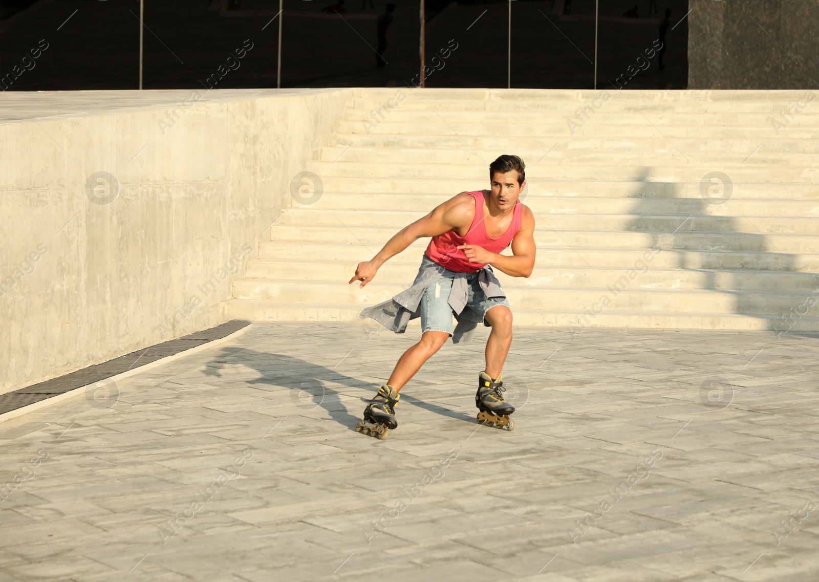 Photo of Handsome young man roller skating on city street