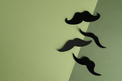 Photo of Fake paper mustaches on color background, flat lay. Space for text
