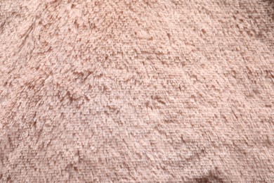 Texture of pink faux fur as background, closeup