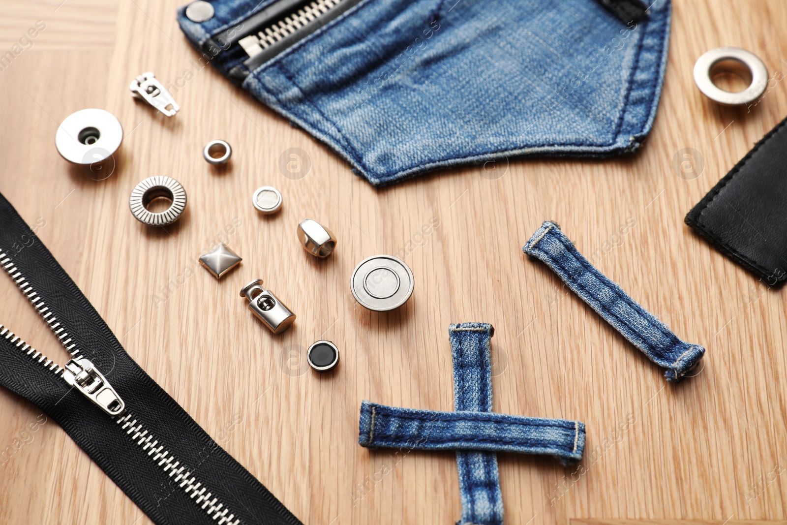 Photo of Composition with garment accessories and cutting details for jeans on table, above view