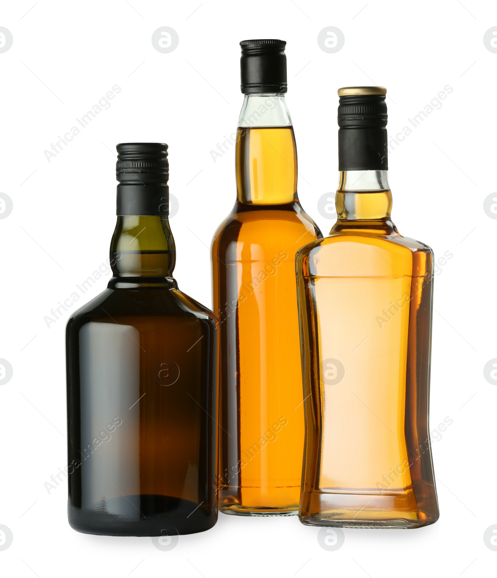 Photo of Different sorts of whiskey in glass bottles isolated on white