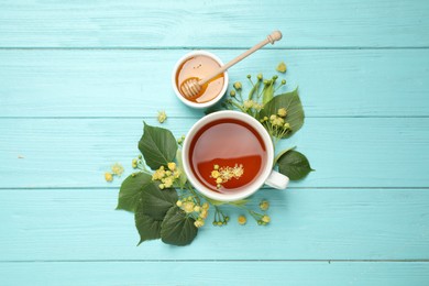 Flat lay composition with tea and linden blossom on light blue wooden table