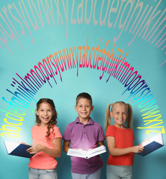 Image of Group of little children reading books on turquoise background 