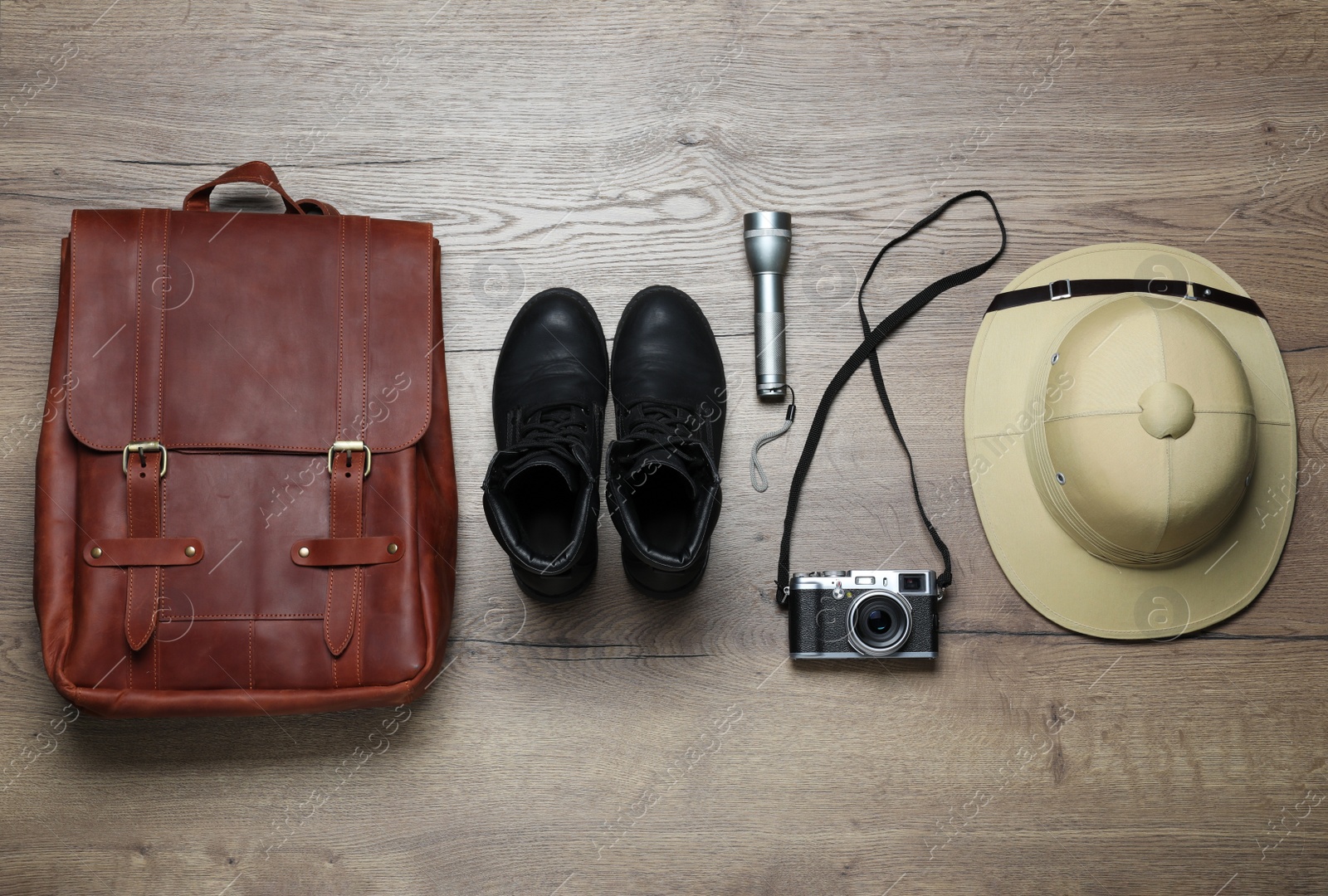 Photo of Flat lay composition with different safari accessories on wooden background