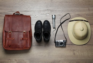 Flat lay composition with different safari accessories on wooden background