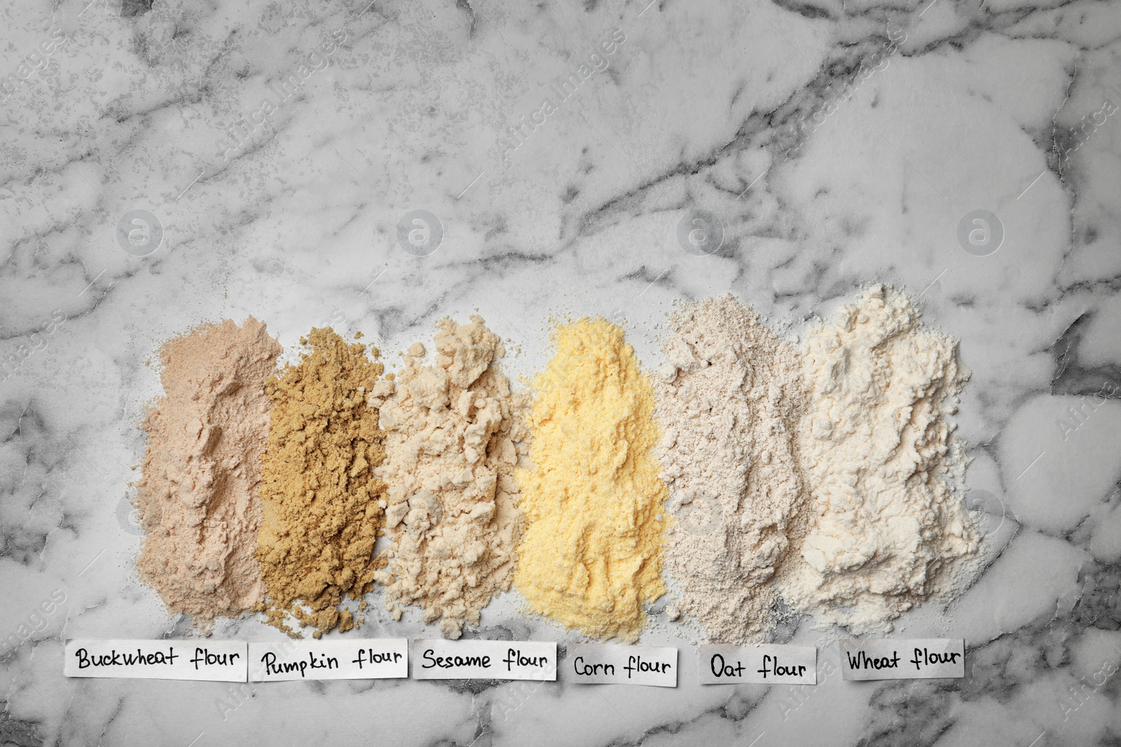 Photo of Composition with different types of flour on light background