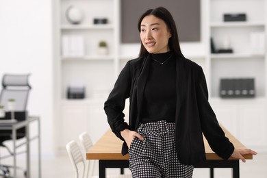 Photo of Portrait of smiling businesswoman in office. Space for text