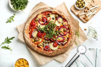 Photo of Flat lay composition with vegetable pizza on white wooden table