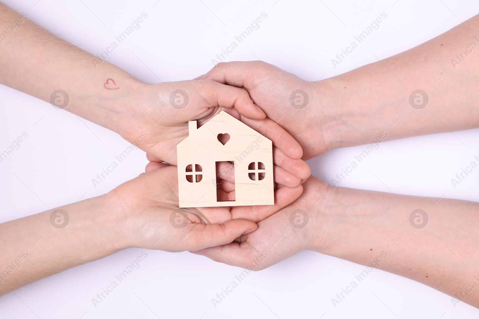 Photo of Home security concept. Couple holding house model on white background, top view