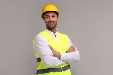 Photo of Engineer in hard hat on grey background