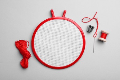 Photo of Flat lay composition with embroidery hoop on light grey background