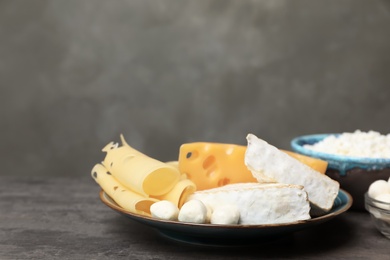 Different dairy products on table against grey background