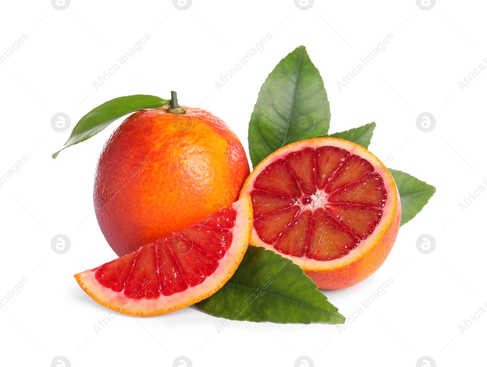 Photo of Whole and cut red oranges with green leaves on white background