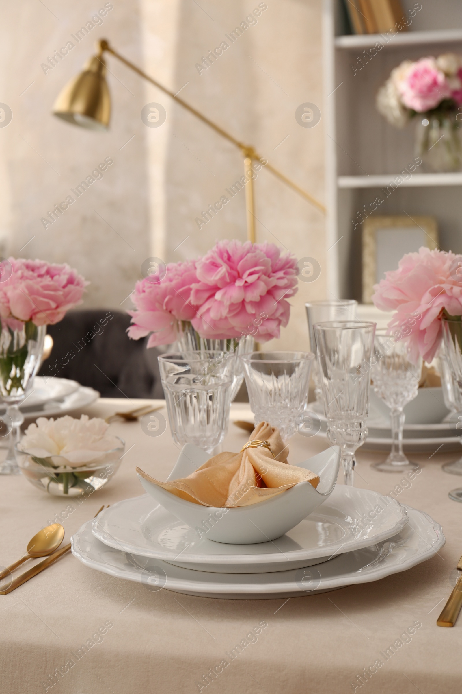 Photo of Stylish table setting with beautiful peonies and fabric napkin indoors