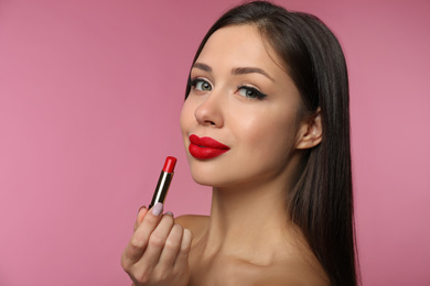 Photo of Beautiful woman with red lipstick on pink background