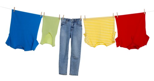 Photo of Different clothes drying on laundry line against white background