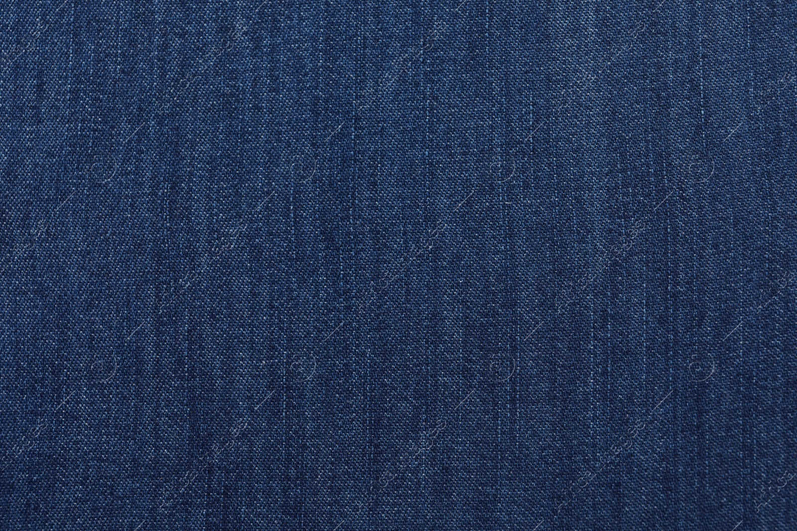 Photo of Texture of dark blue jeans as background, closeup