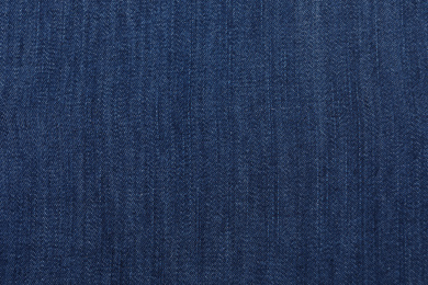 Photo of Texture of dark blue jeans as background, closeup