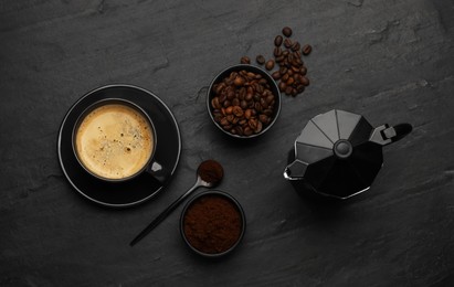 Photo of Flat lay composition with coffee grounds and roasted beans on black background