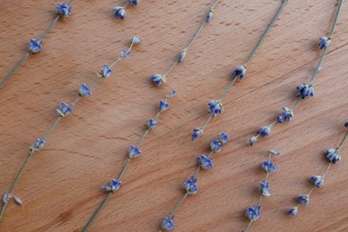 Photo of Beautiful lavender flowers on wooden table, flat lay
