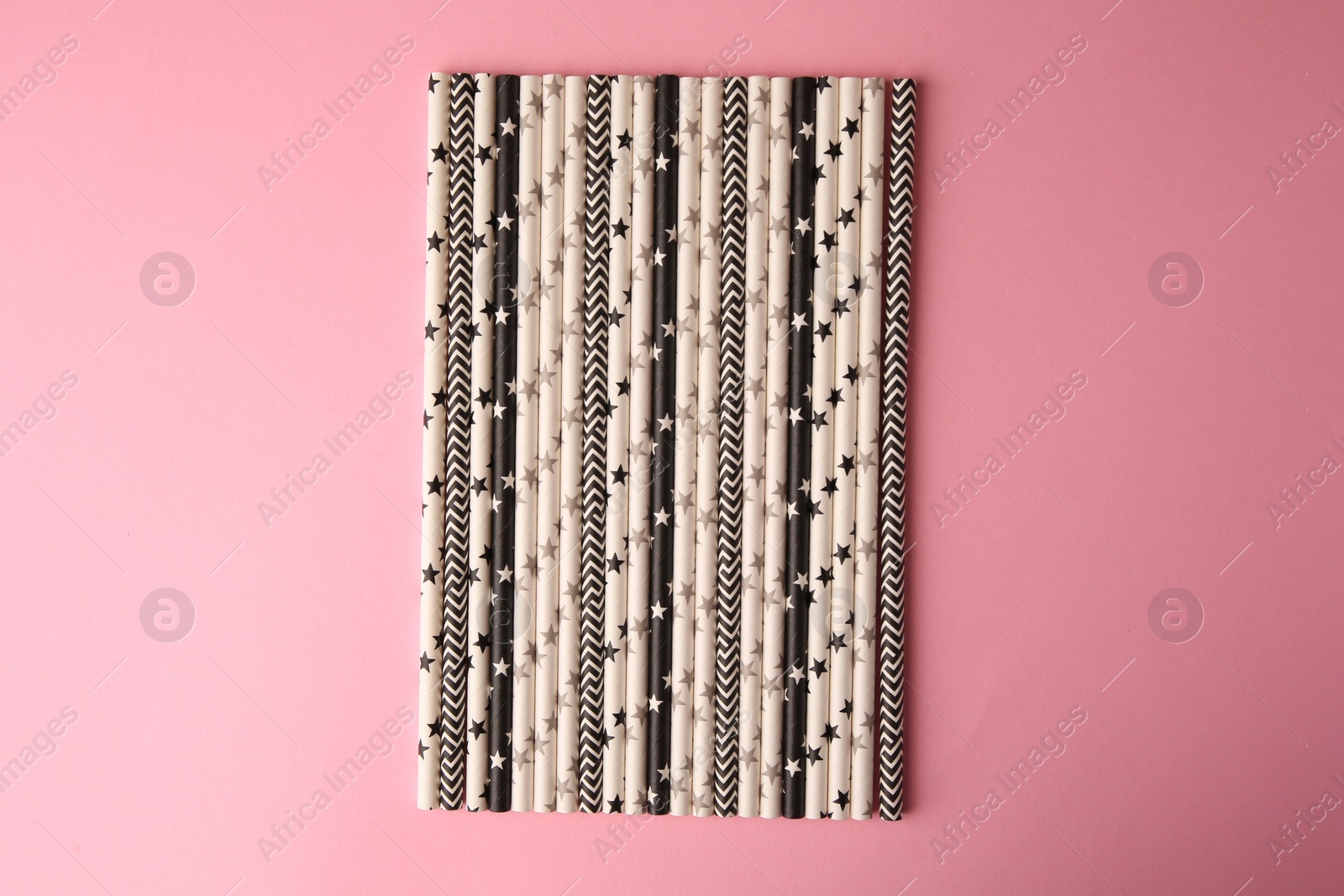 Photo of Many paper drinking straws on pink background, flat lay