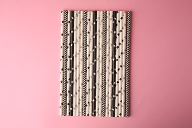 Many paper drinking straws on pink background, flat lay