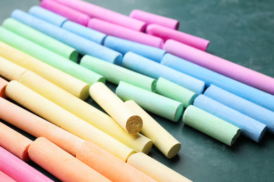 Pieces of color chalk on greenboard, closeup