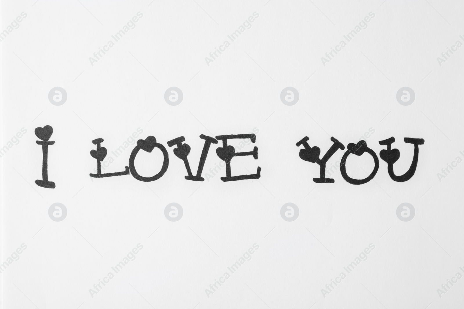 Photo of Handwritten text I Love You on white background