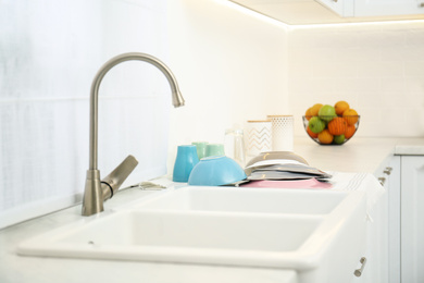 Photo of Clean dishes drying on counter in kitchen