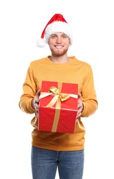 Photo of Young man with Christmas gift on white background