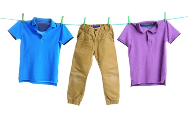 Child clothes on laundry line against white background