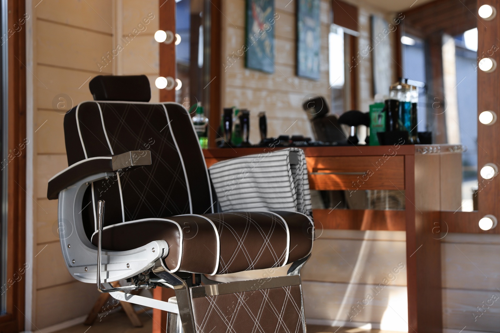 Photo of Stylish hairdresser's workplace with professional armchair in barbershop