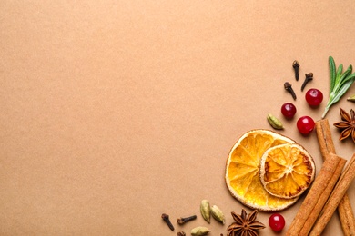 Photo of Different mulled wine ingredients on brown background, flat lay. Space for text