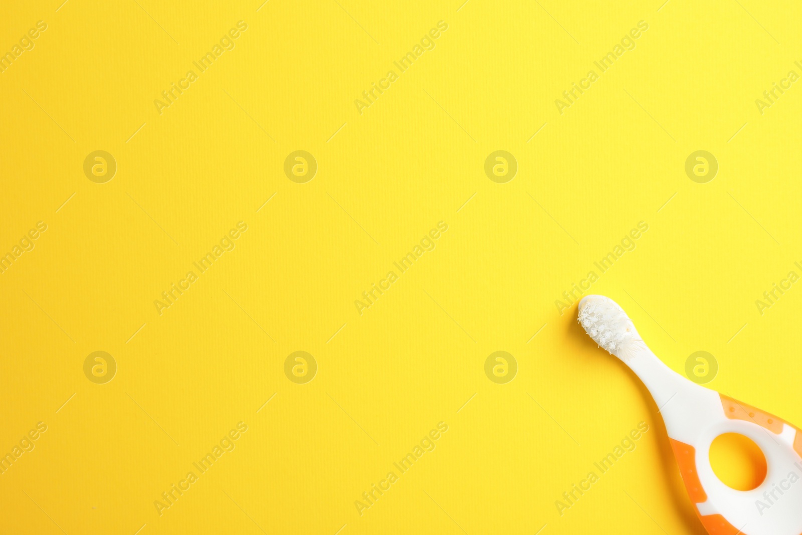 Photo of Manual toothbrush for child on color background, top view with space for text