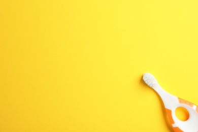 Photo of Manual toothbrush for child on color background, top view with space for text