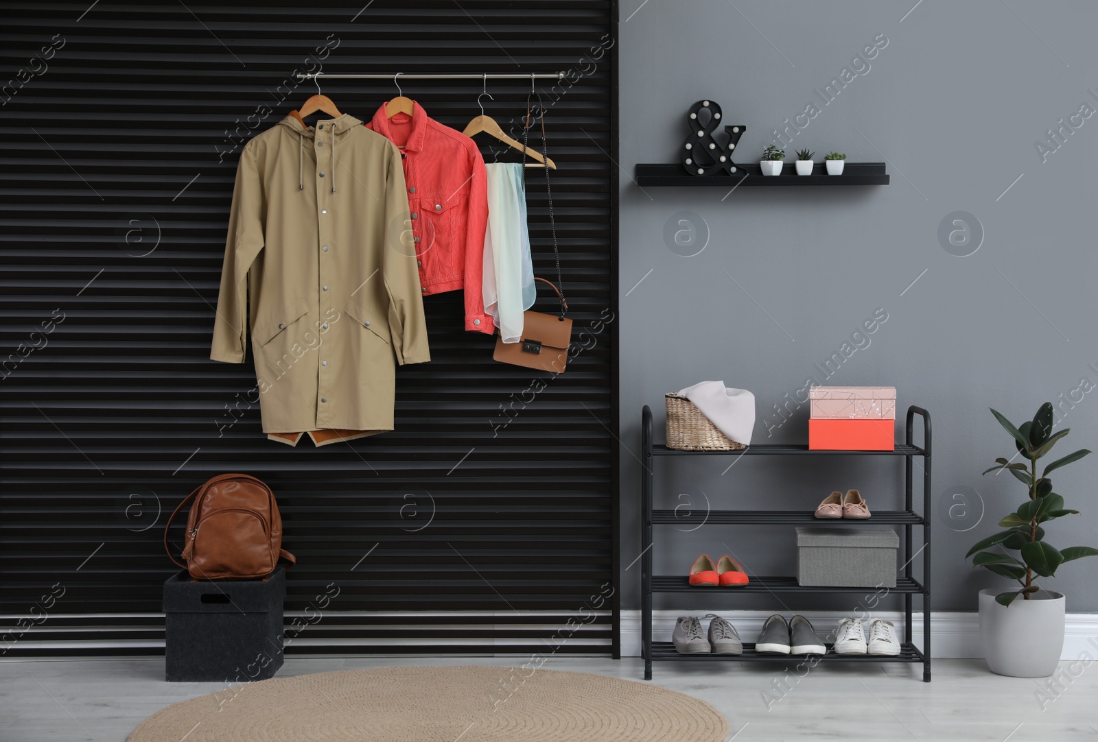 Photo of Hallway interior with stylish furniture, clothes and accessories