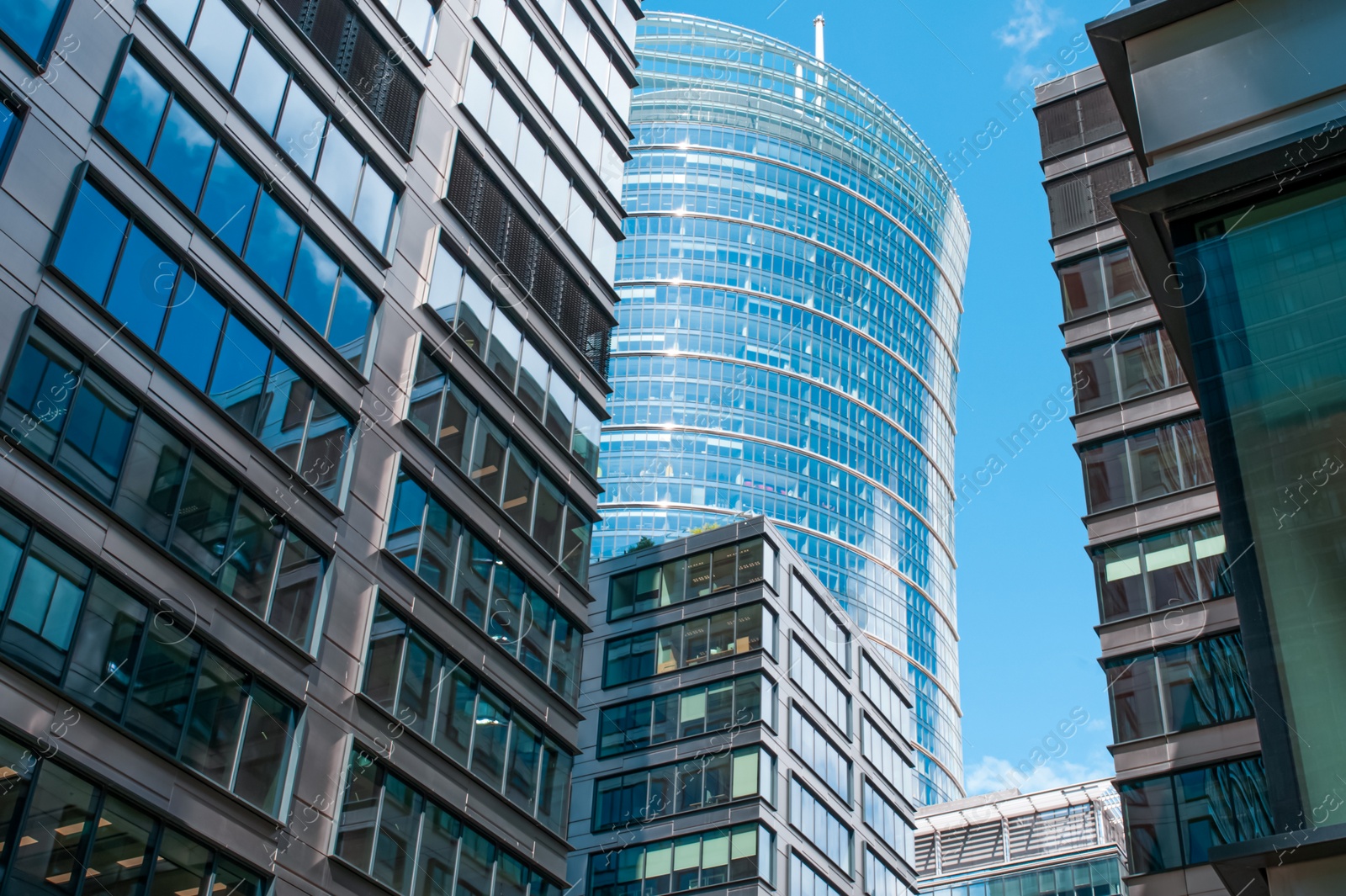 Photo of Stylish buildings with many windows under cloudy sky