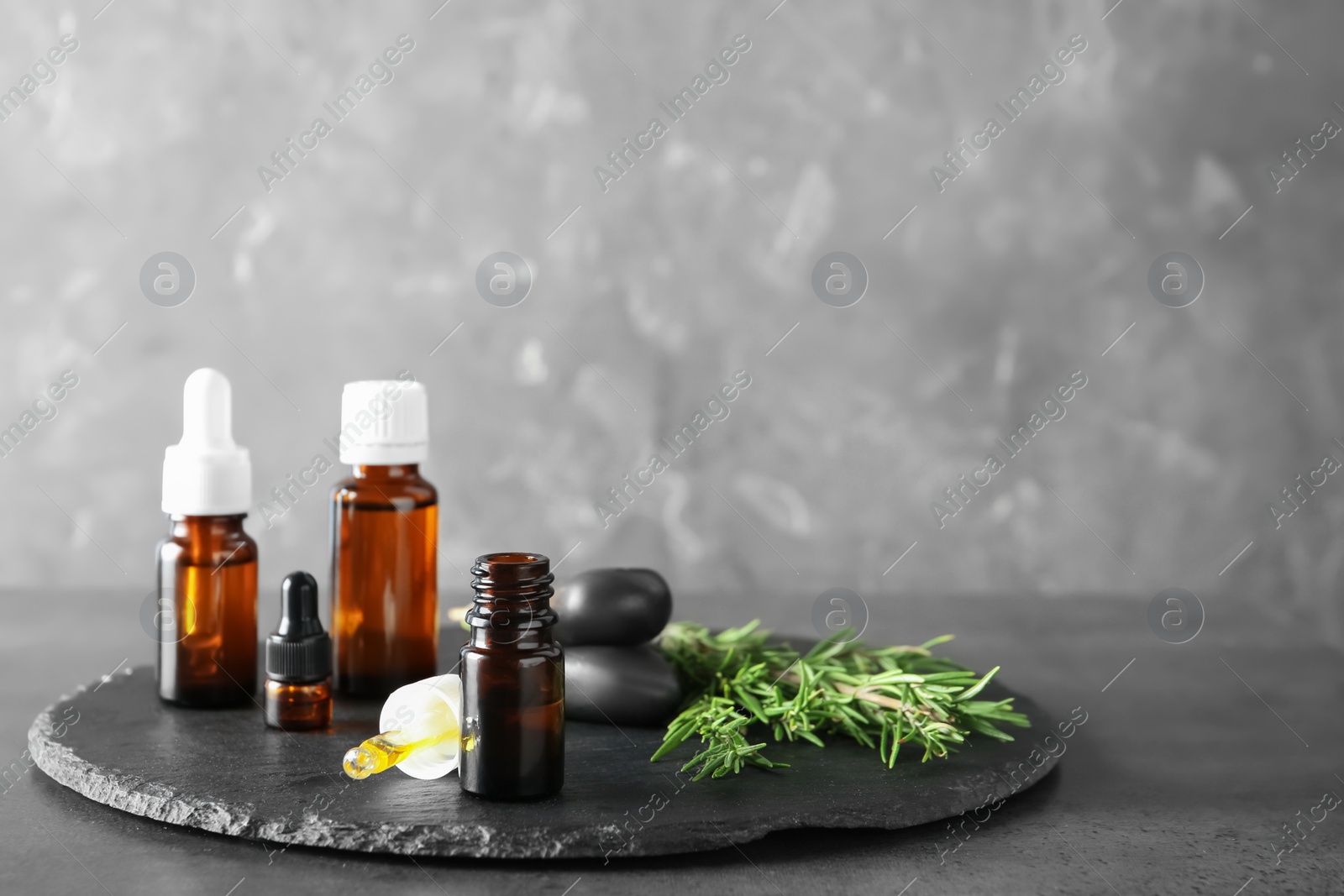 Photo of Spa composition with fresh rosemary oil on table