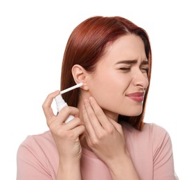 Photo of Unhappy woman using ear spray on white background