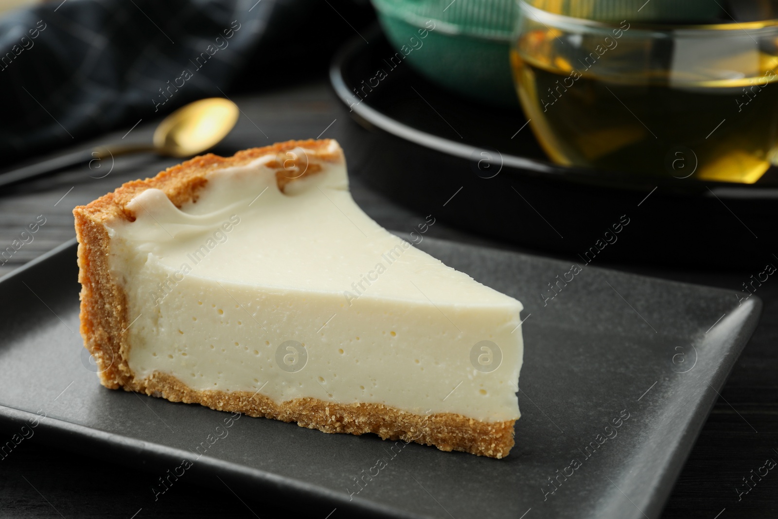 Photo of Piece of tasty vegan tofu cheesecake on table, closeup