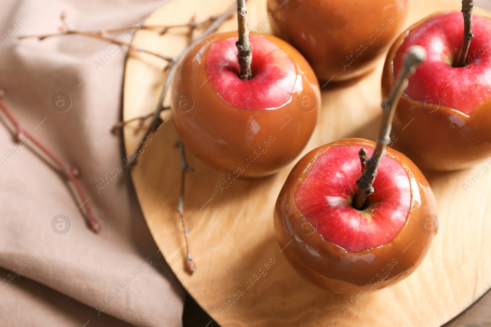 Photo of Plate with delicious caramel apples, closeup