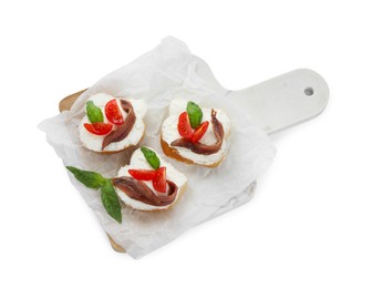 Photo of Delicious sandwiches with cream cheese, anchovies, tomatoes and basil on white background, top view