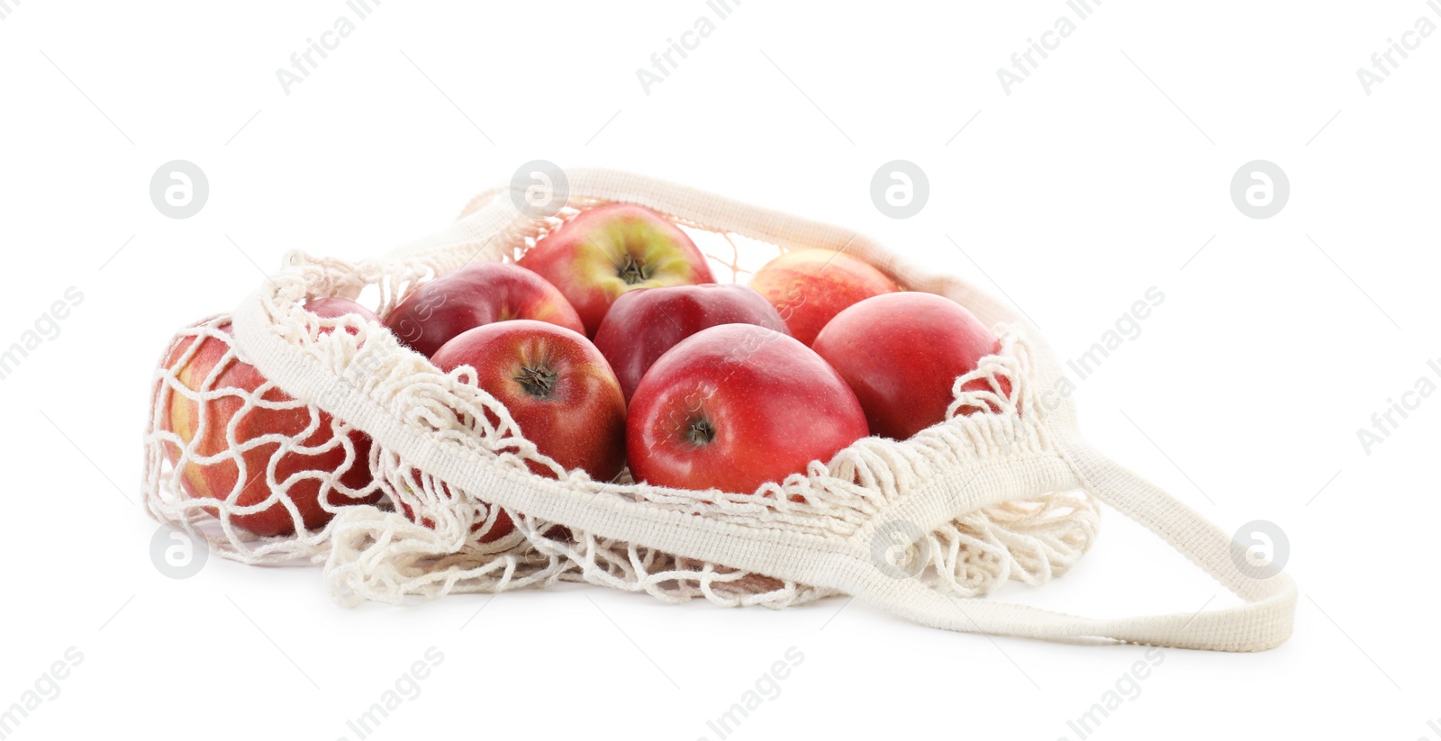 Photo of String bag with apples isolated on white