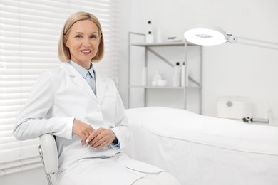 Photo of Portrait of happy dermatologist in modern clinic